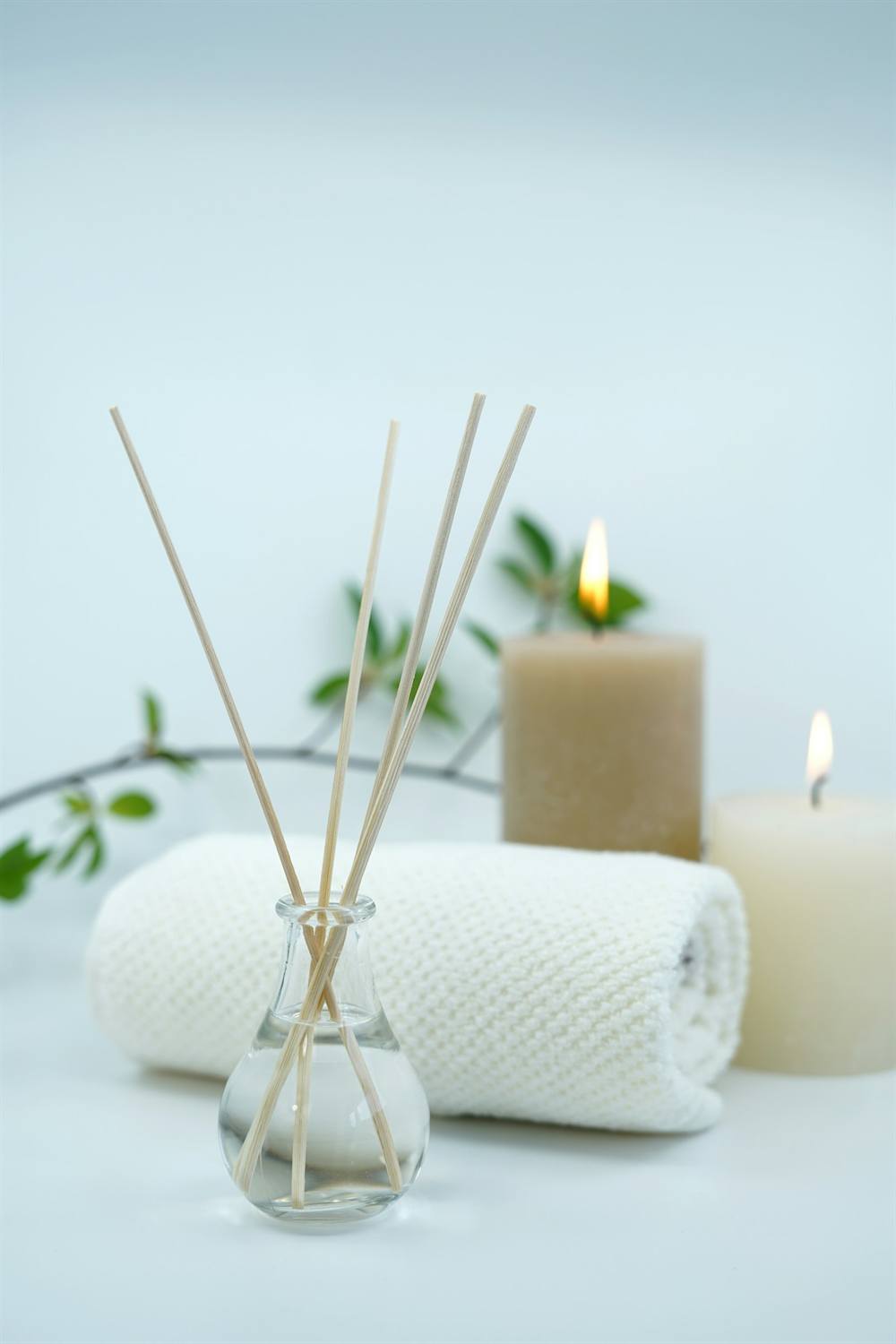 Reed diffuser, folded towel and candles in the treatment room